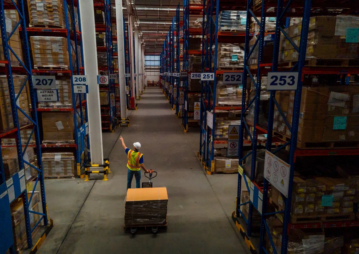 Forklift Warehouse forklift in operation moving palletized freight for logistics fulfillment